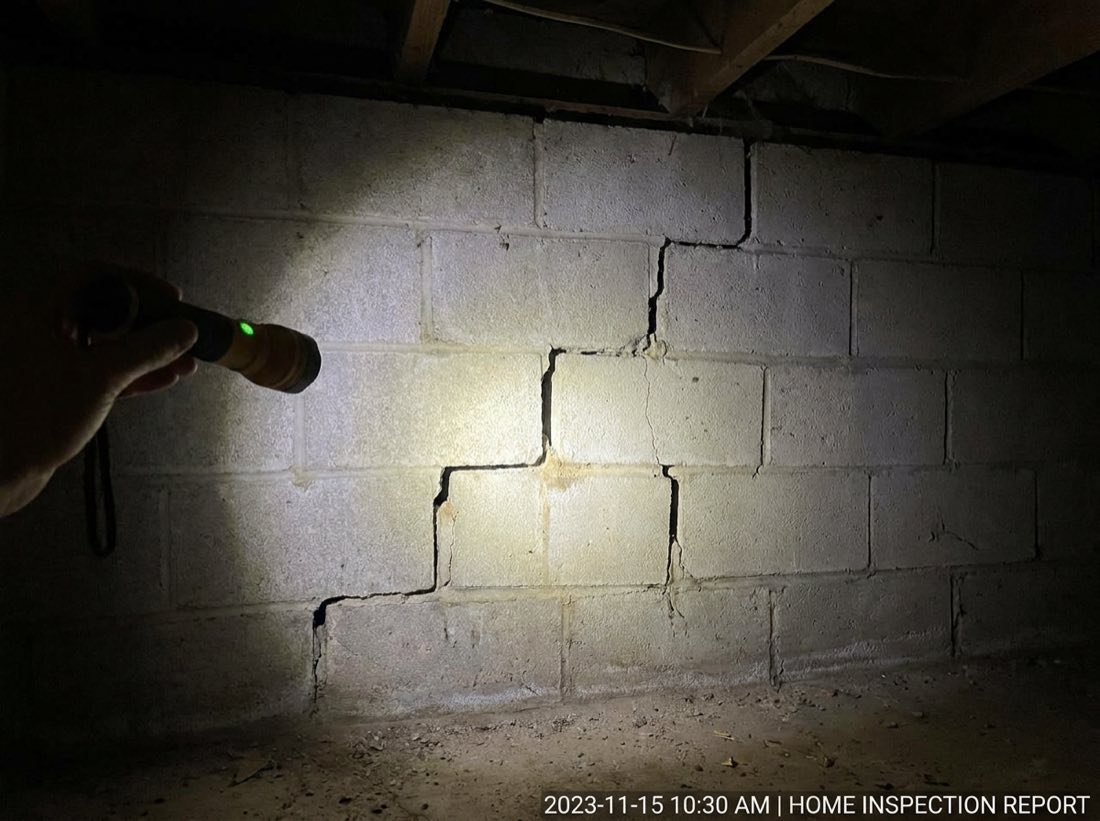 Stair-step crack in a concrete block foundation wall