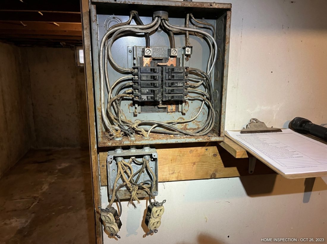 Outdated electrical panel with aluminum wiring and double-tapped breakers